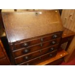 An early 19th century provincial oak slopefront four drawer writing bureau (lacking supports), width