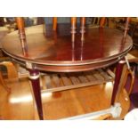 A French mahogany and gilt brass mounted D-end extending dining table, having a pull-out action (