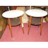 A pair of 1950s formica topped circular two-tier stained beech occasional tables, dia. 55cm
