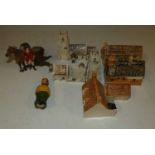 A small box of ceramic model churches, houses, polychrome painted metal huntsman etc (7)