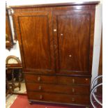 A Regency mahogany and ebony strung linenpress, the twin recessed panelled upper doors enclosing