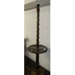 An early 20th century barley twist turned oak standard lamp, with dished centre tier