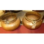 A pair of Eastern copper and brass swing handled bulbous cauldrons, each dia.46cm