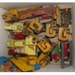 A box of loose playworn Dinky diecast toy vehicles, mostly construction related