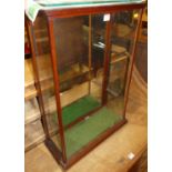 A circa 1900 mahogany table-top glazed shop display cabinet, having mirrored inset single rear door,