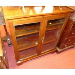 An early 20th century mahogany and stained pine low double door glazed bookcase, width 84cm