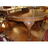 An early 20th century mahogany D-end extending dining table, having a wind-out action, two extra