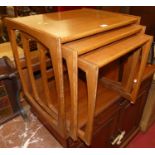 A 1970s teak nest of three occasional tables, the largest width 53.5cm