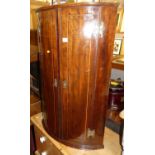 A 19th century mahogany bowfront double door hanging corner cupboard, height 97cm