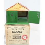 A Dinky Toys Pre-War No.45 tinplate Garage comprising of green, cream, and orange body with green