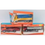 A group of 3 boxed Tekno trucks as follows: No.915 Ford D 0810 with a red cab and grey truck bed,