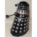 A large Dalek, of Fibreglass and wood construction with caster wheels fitted to base (36 inches high