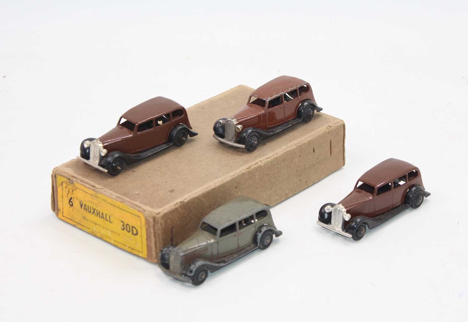 Dinky Toys No.30d original Vauxhall Trade box, containing 4 examples, 3 brown and 1 grey, two in