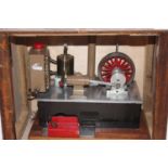 A wooden cased model of a beam engine powered by a stirling cycle hot air engine with spirit