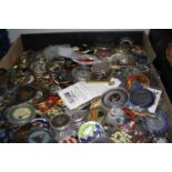 A large collection of assorted mostly American enamelled tokens and trinkets