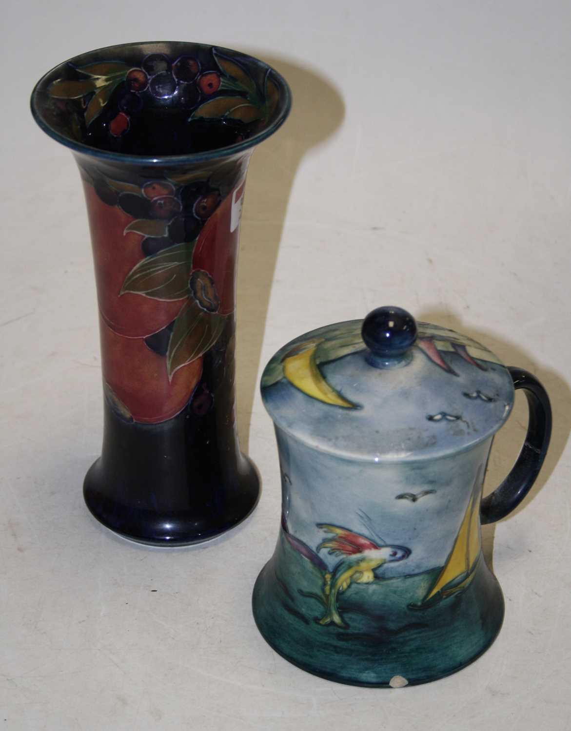 A Moorcroft Pottery lidded mug of waisted cylindrical form, tubeline decorated in the Bermuda