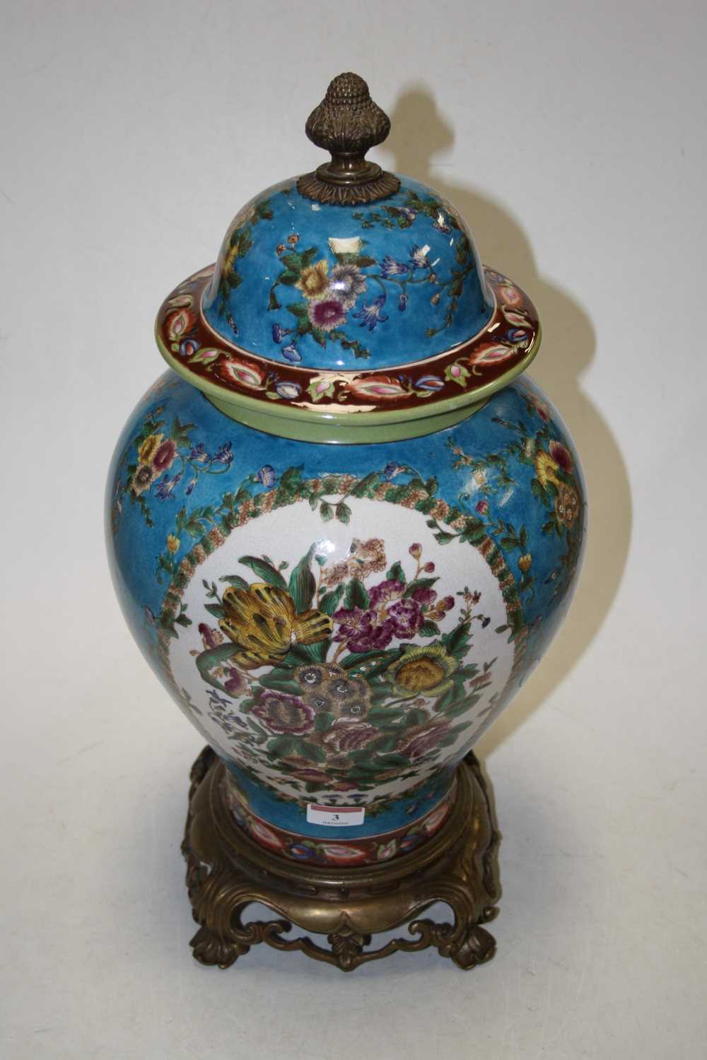 An 18th century style brass mounted jar and cover, of baluster form, with floral decoration, mounted