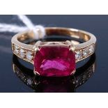 A 9ct gold pink sapphire and diamond set dress ring, the four claw set cushion cut sapphire weighing