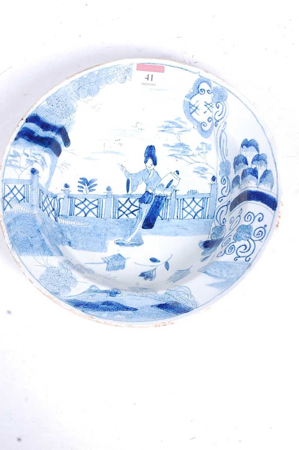 An 18th century tin-glazed dish, decorated in the Chinese taste with a figure before a fence, dia. - Image 3 of 5