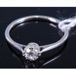 A white metal diamond solitaire ring, the claw set brilliant weighing approx 0.2 carats, 2g, size M