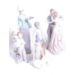 A Lladro Spanish porcelain figure group of a mother and child, h.36cm; together with three other