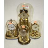 A 20th century Kundo brass anniversary clock housed under a glass dome, 31cm high overall,