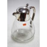 A lemonade jug, having an etched clear glass body with silver plated mounts, height 28cm