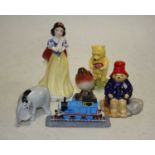 A Royal Doulton Winnie the Pooh collection figure, Winnie Pooh and the present, and Eeyore, a