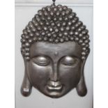A large silvered composition buddha wall mask, 58cm high