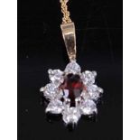 A modern yellow metal red and white stone flower head pendant on 9ct gold finelink neck chain