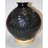 A Mexican Reyna Simon Lopez pottery vase, of globular form with incised decoration, upon a wicker