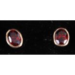 A pair of modern 9ct gold and garnet set ear studs, 2.2g, 9 x 7mm