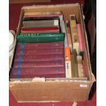 A box containing a collection of various books, to include The Folio Shakespeare in six volumes