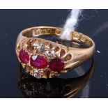An 18ct gold ruby and diamond dress ring, the stones in a carved setting, Note: three diamonds