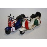 A modern painted tin plate model of a Vespa Scooter, together with one other similar example (2)