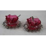 A pair of Victorian cranberry glass open salts, each having a pinched rim and shell border, raised