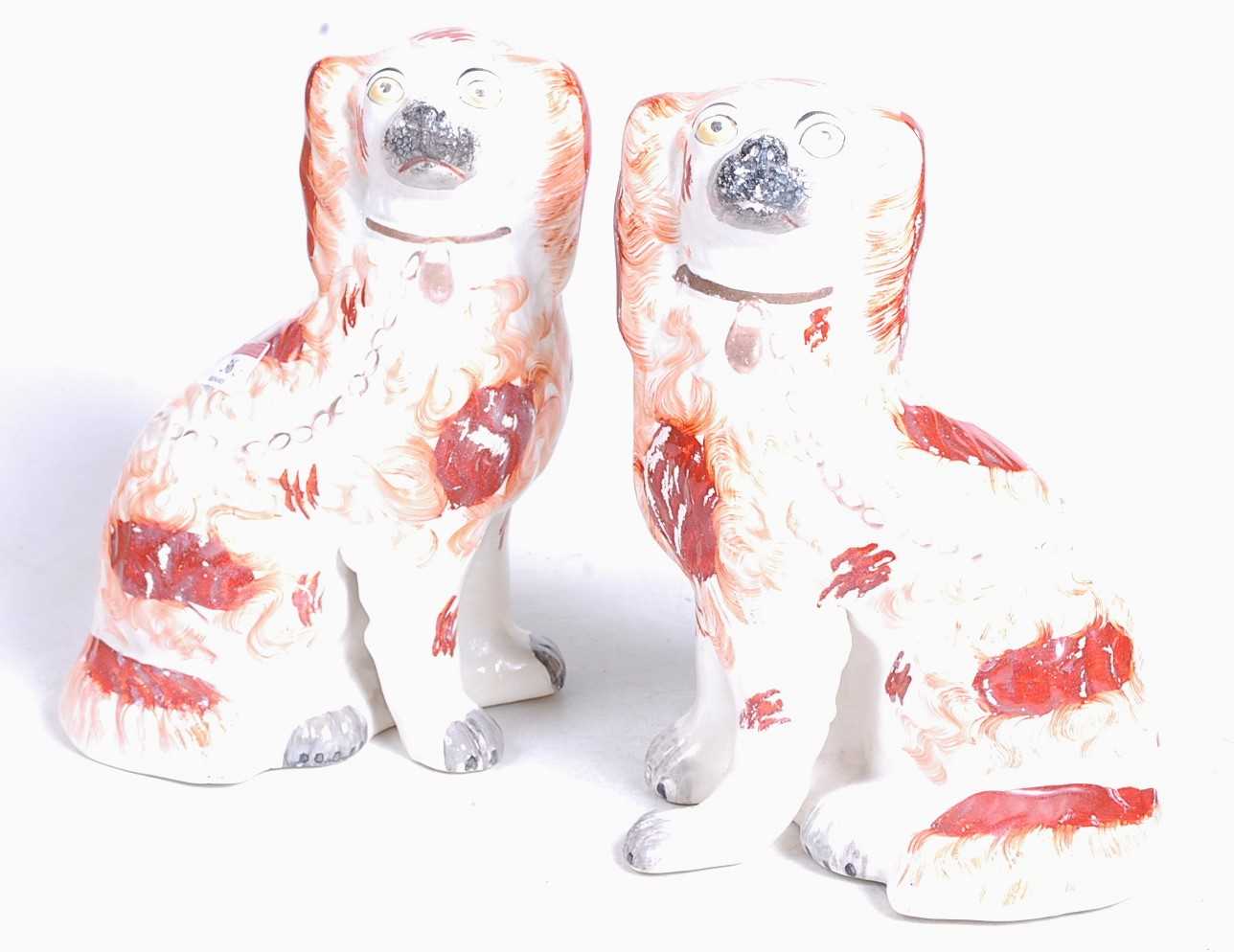 A pair of Staffordshire pottery models of seated spaniels, each h.24cmCondition report: Restored.