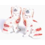A pair of Staffordshire pottery models of seated spaniels, each h.24cmCondition report: Restored.