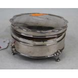 A George V silver trinket box of shaped circular form, the hinged lid with engine turned
