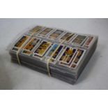 A large collection of assorted cigarette cards, to include Gallagher Ltd Army Badges, Famous Film