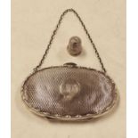 A George V silver ladies purse of oval form having engine turned decoration and monogrammed