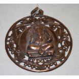 A copper alloy plaque of circular form, the centre decorated in relief with a figure of Ganesh