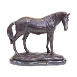 A bronze model of a horse, shown in standing pose, mounted upon a veined black marble plinth, h.23cm