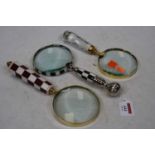 A collection of three oversize magnifying glasses
