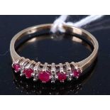 A 9ct gold, ruby and diamond set half hoop ring, arranged as five graduated round cut rubies