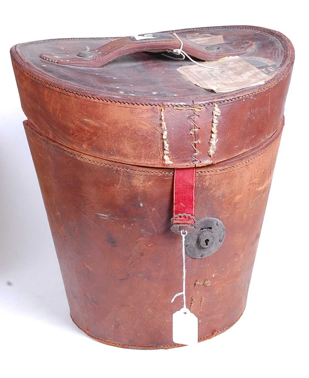 A Victorian tan leather top-hat box, with fitted red silk interior, h.34cm