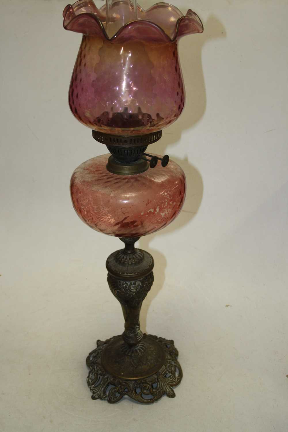 A late 19th century brass and rose-tinted glass oil lamp, h.64cm; together with another similar (2) - Image 3 of 4