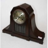 A 1920s oak cased eight-day mantel clock, the silvered dial showing Arabic numerals above a
