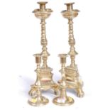 A pair of Victorian brass table candlesticks, each of baluster form, standing on a circular foot,