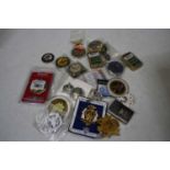 A collection of miscellaneous items to include pocket cigarette lighters, commemorative badges, etc